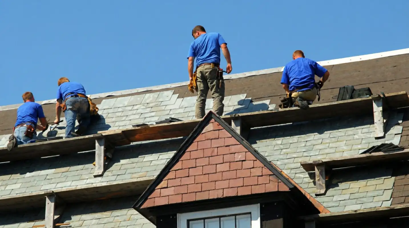 Roof replacement in progress with a team of professional contractors installing new shingles on a residential home in Pembroke Pines, FL